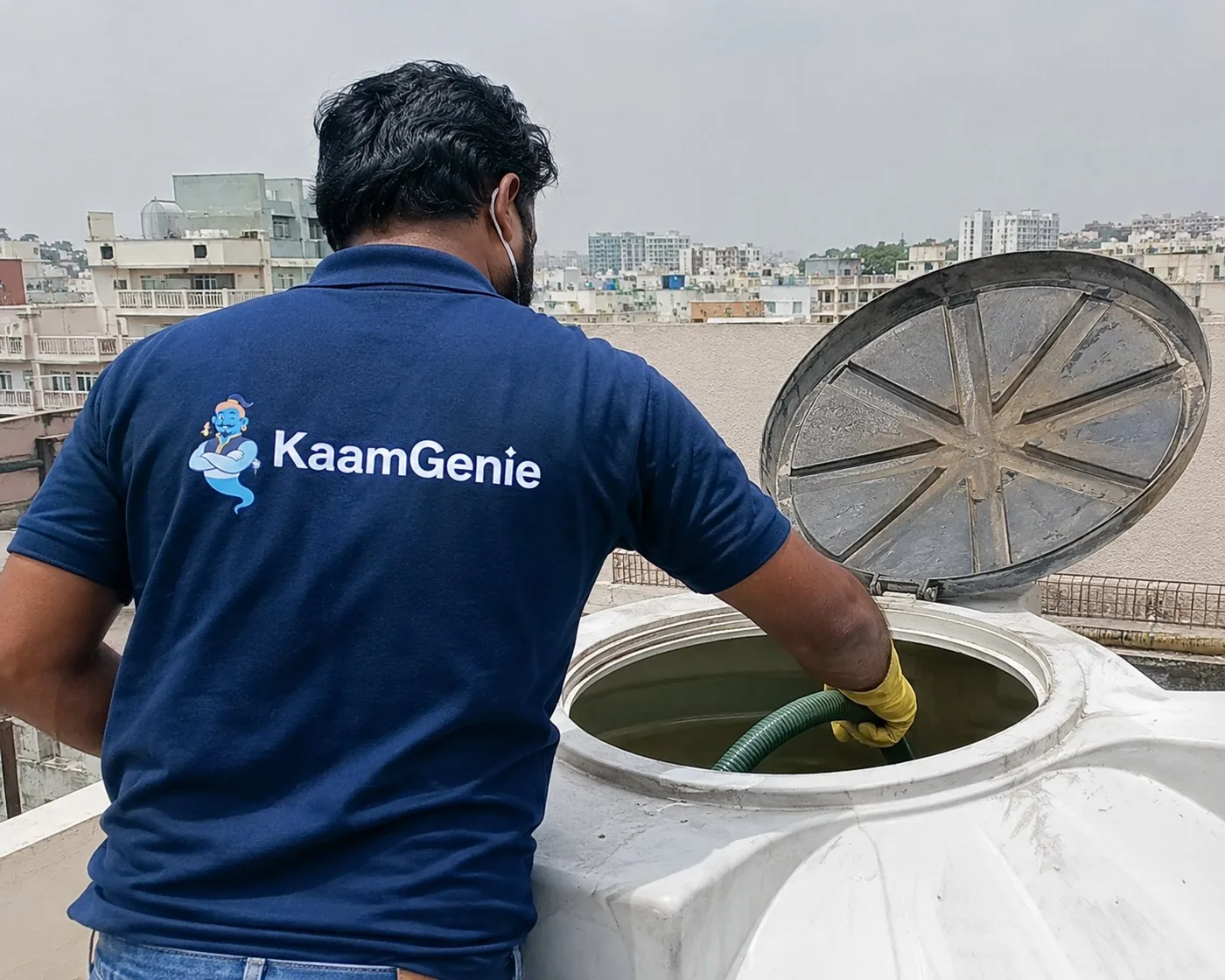 KaamGenie crew cleaning a rooftop water tank in Delhi