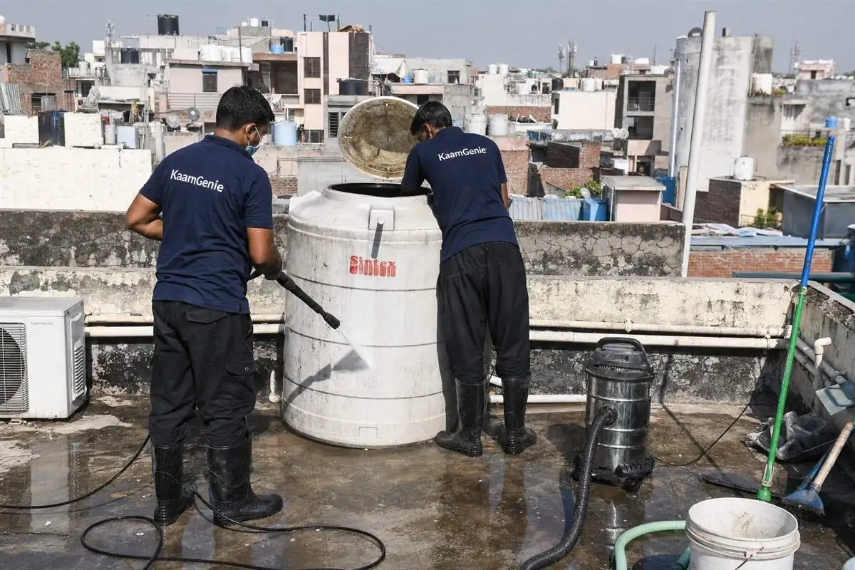 KaamGenie crew cleaning a water tank in Asola, Delhi