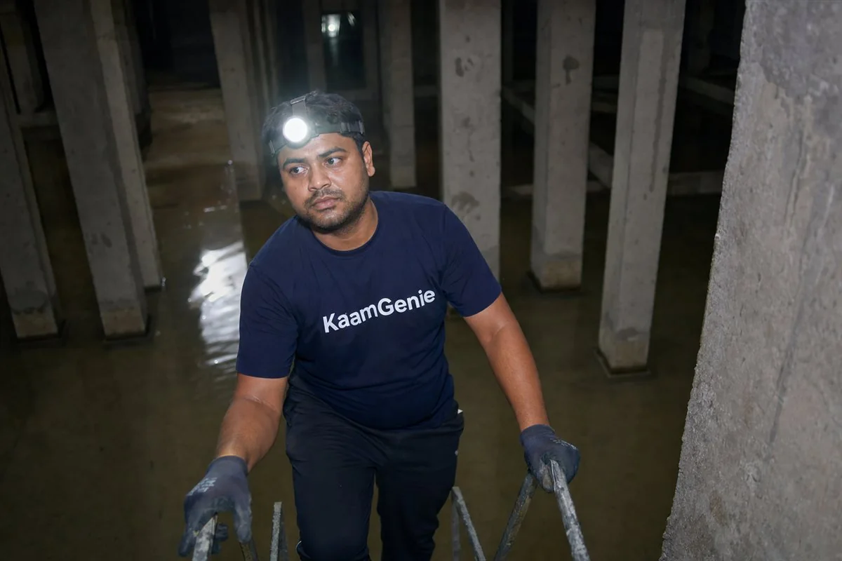 Close-up of chalky white calcium scale on the wall and outlet fitting of a Gurgaon condominium overhead tank before descaling