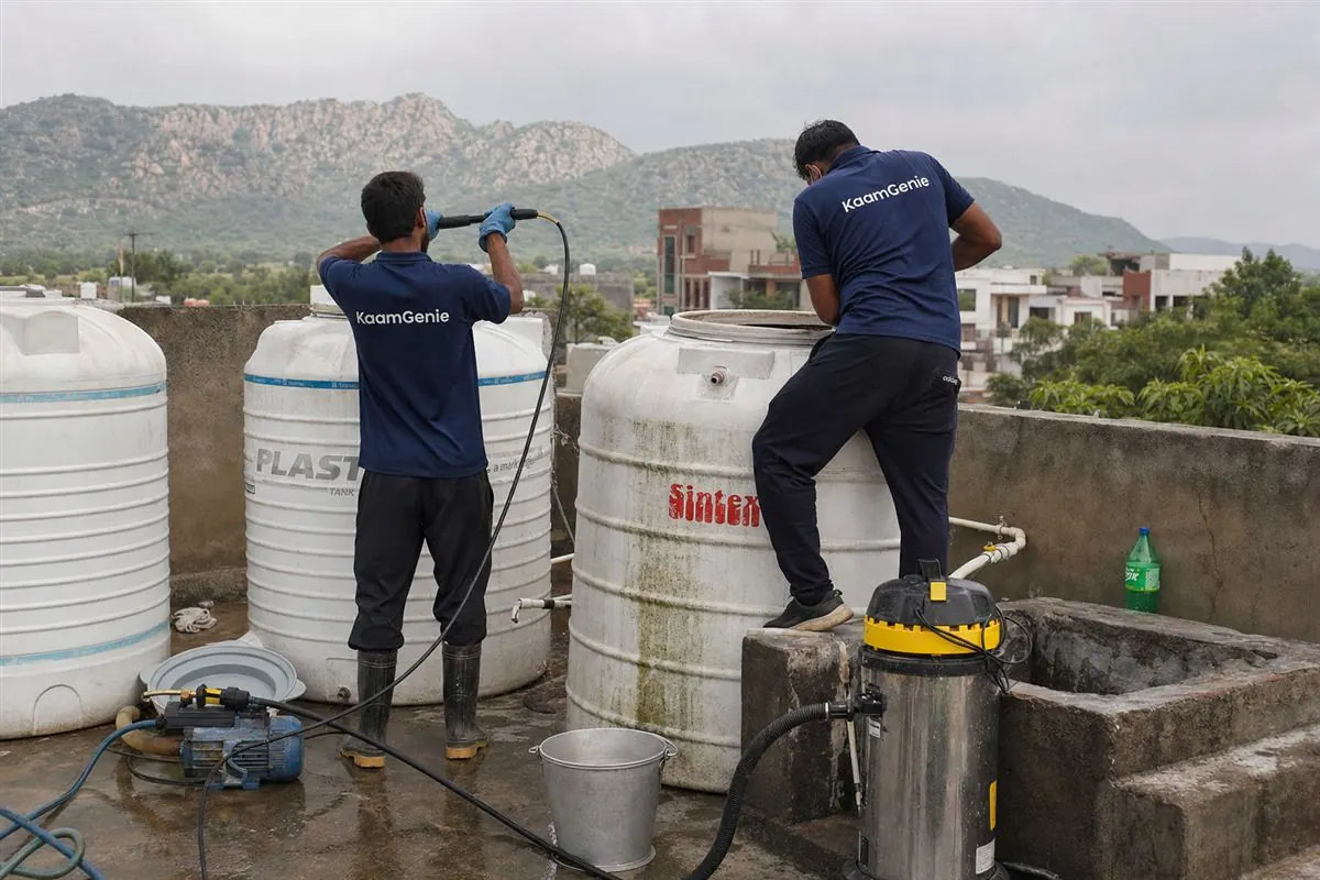 KaamGenie crew cleaning a water tank in Baselwa Colony, Faridabad