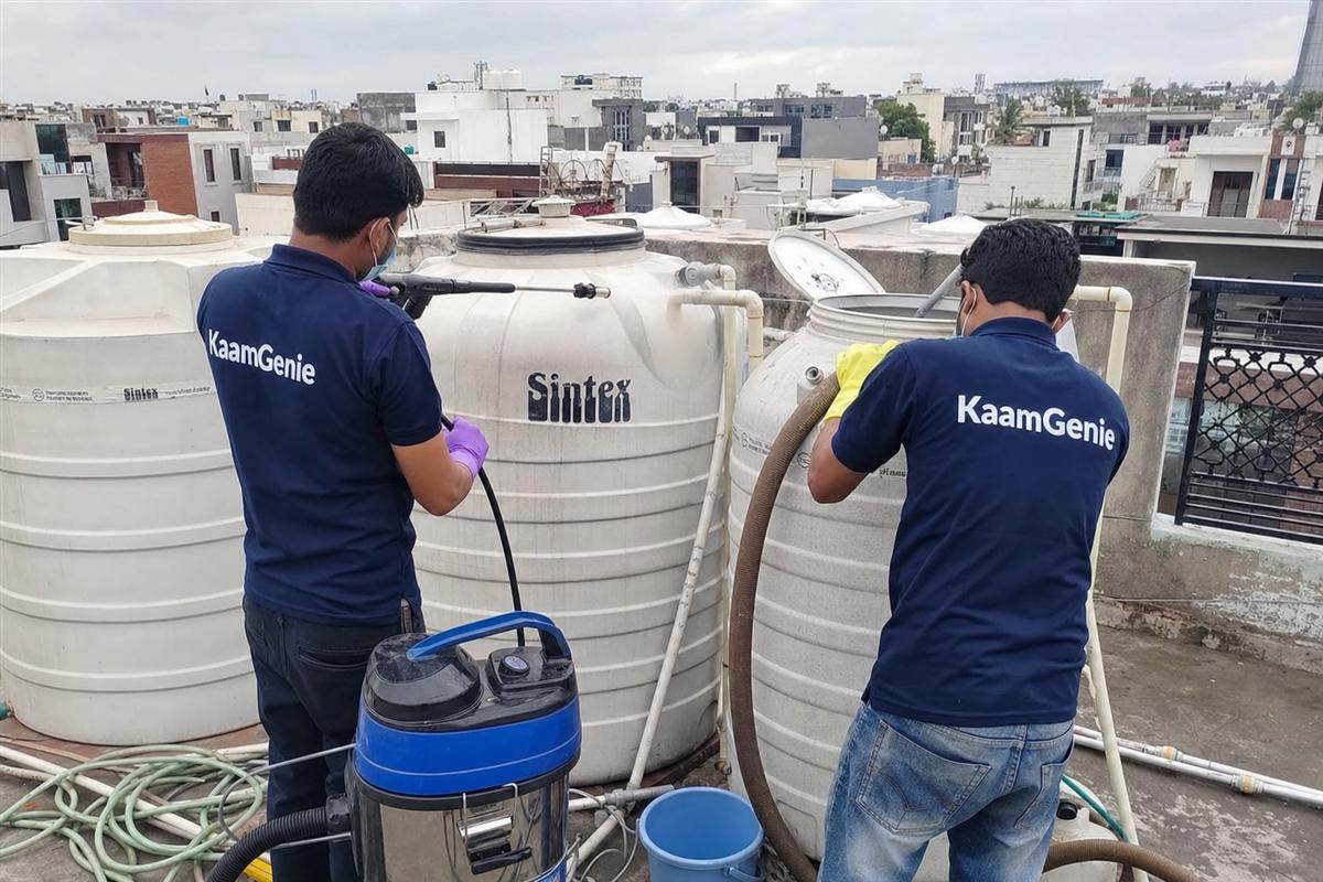 KaamGenie crew cleaning a water tank in Bhatia Colony, Faridabad