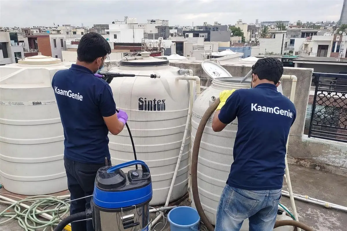 KaamGenie crew cleaning a water tank in Bhatia Colony, Faridabad