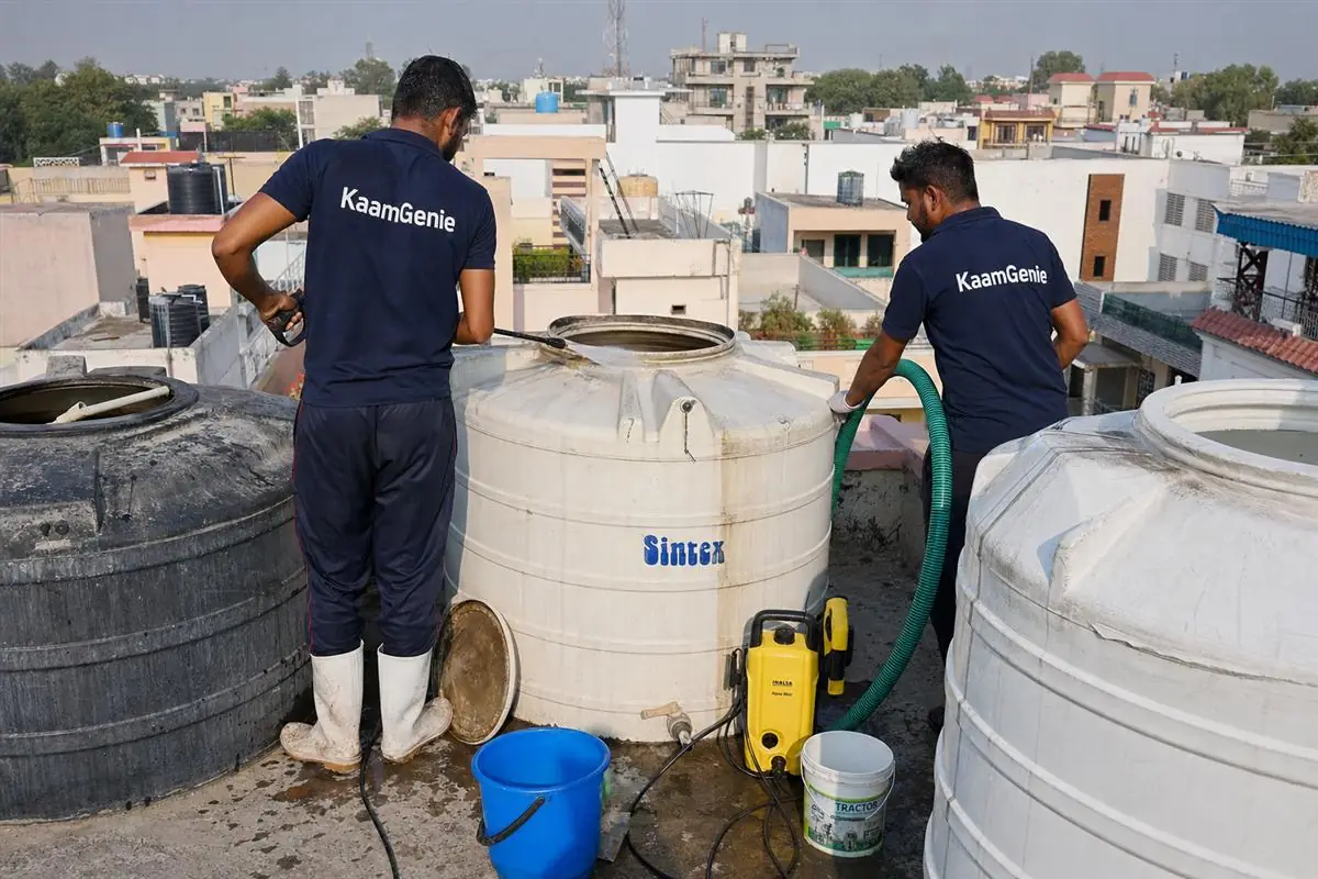 KaamGenie crew cleaning a water tank in Charmwood Village, Faridabad