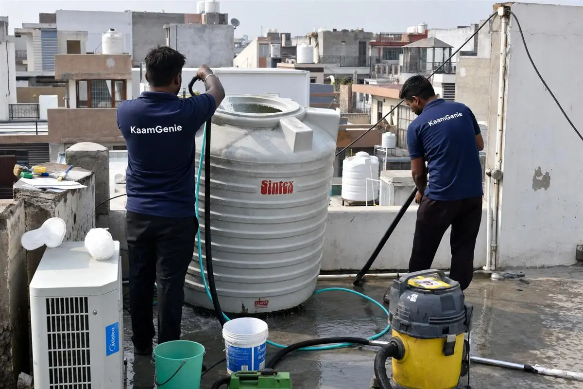 KaamGenie crew cleaning a water tank in Faridpur, Faridabad