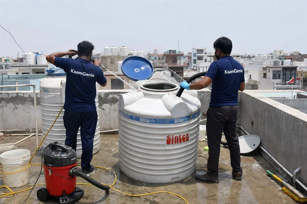 KaamGenie crew cleaning a water tank in Gandhi Colony, Faridabad