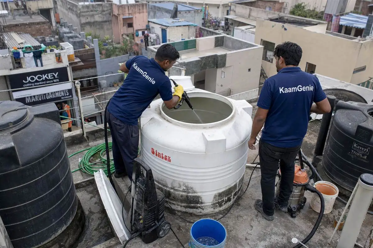 KaamGenie crew cleaning a water tank in Hardware Chowk, Faridabad