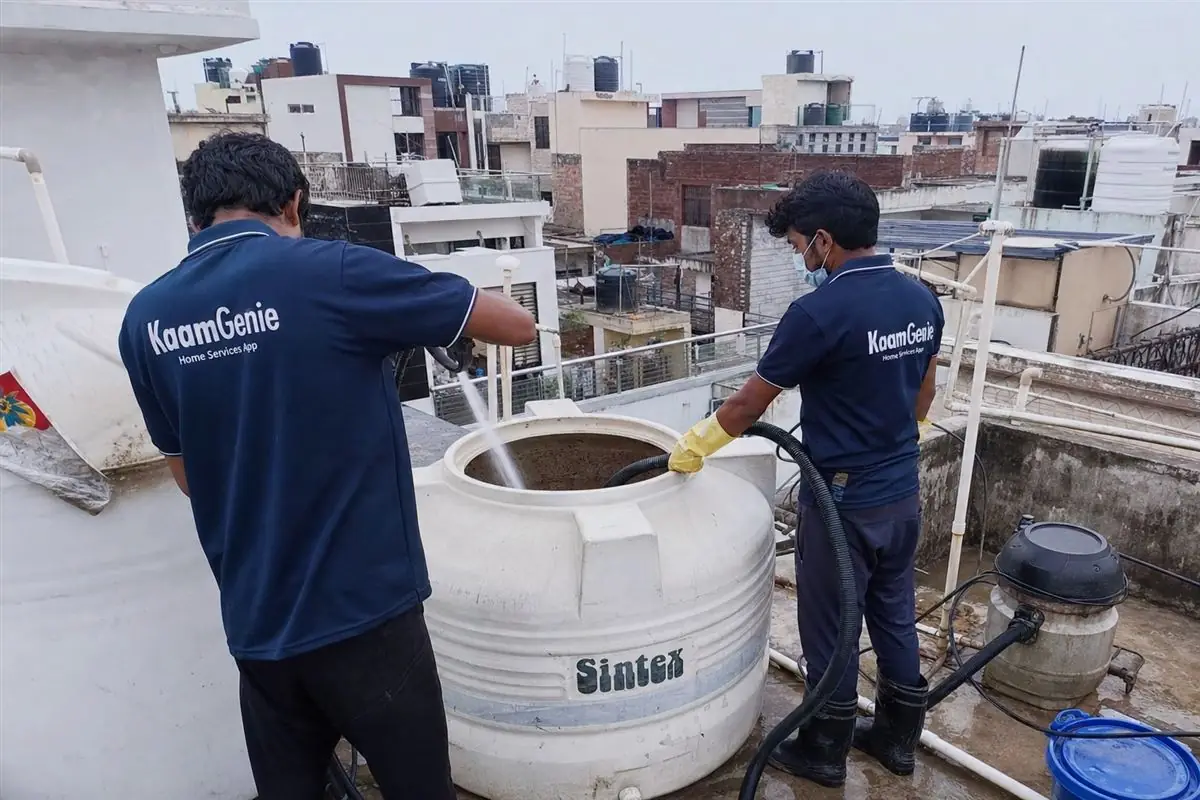 KaamGenie crew cleaning a water tank in Jeevan Nagar, Faridabad