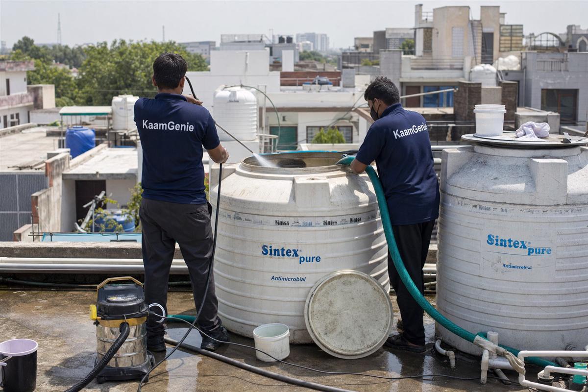KaamGenie crew cleaning a water tank in Krishna Colony, Faridabad