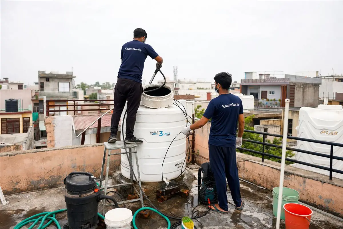 KaamGenie crew cleaning a water tank in Mujesar, Faridabad