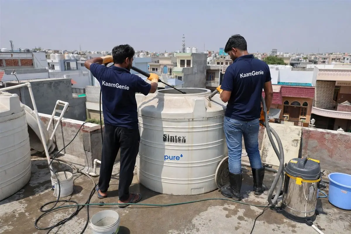 KaamGenie crew cleaning a water tank in Sector 30, Faridabad