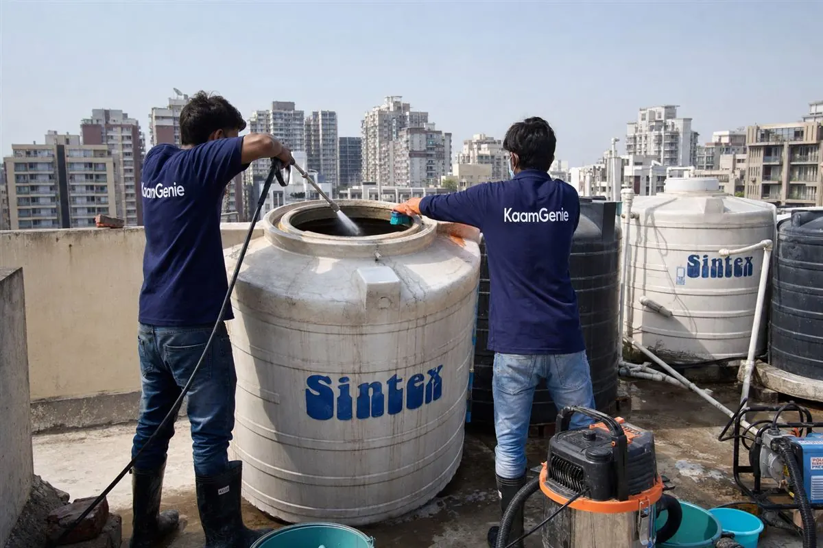 KaamGenie crew cleaning a water tank in Sector 78, Faridabad