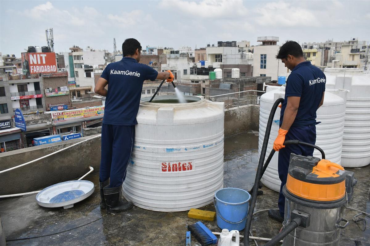 KaamGenie crew cleaning a water tank in Sehatpur, Faridabad