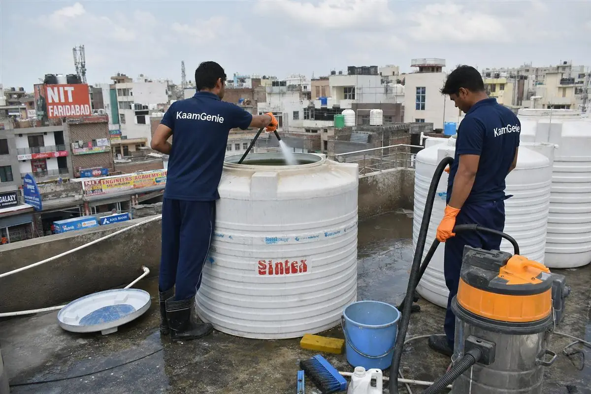 KaamGenie crew cleaning a water tank in Sehatpur, Faridabad