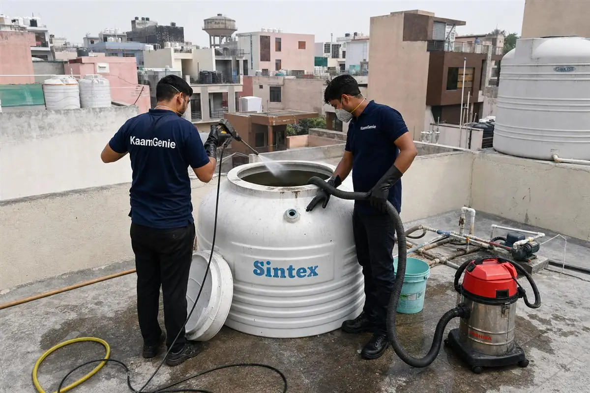 KaamGenie crew cleaning a water tank in Shastri Colony, Faridabad