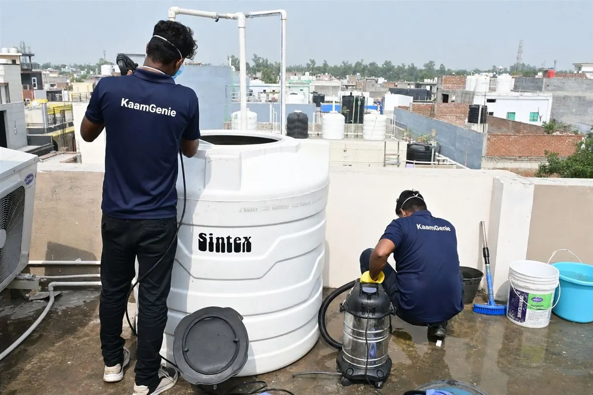 KaamGenie crew cleaning a water tank in Sotai, Faridabad