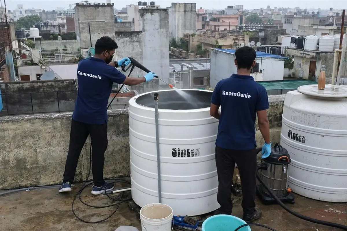 KaamGenie crew cleaning a water tank in Gharoli, Delhi