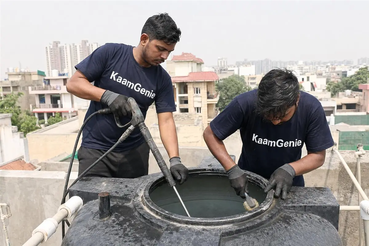 KaamGenie crew cleaning a water tank in Chi, Greater Noida