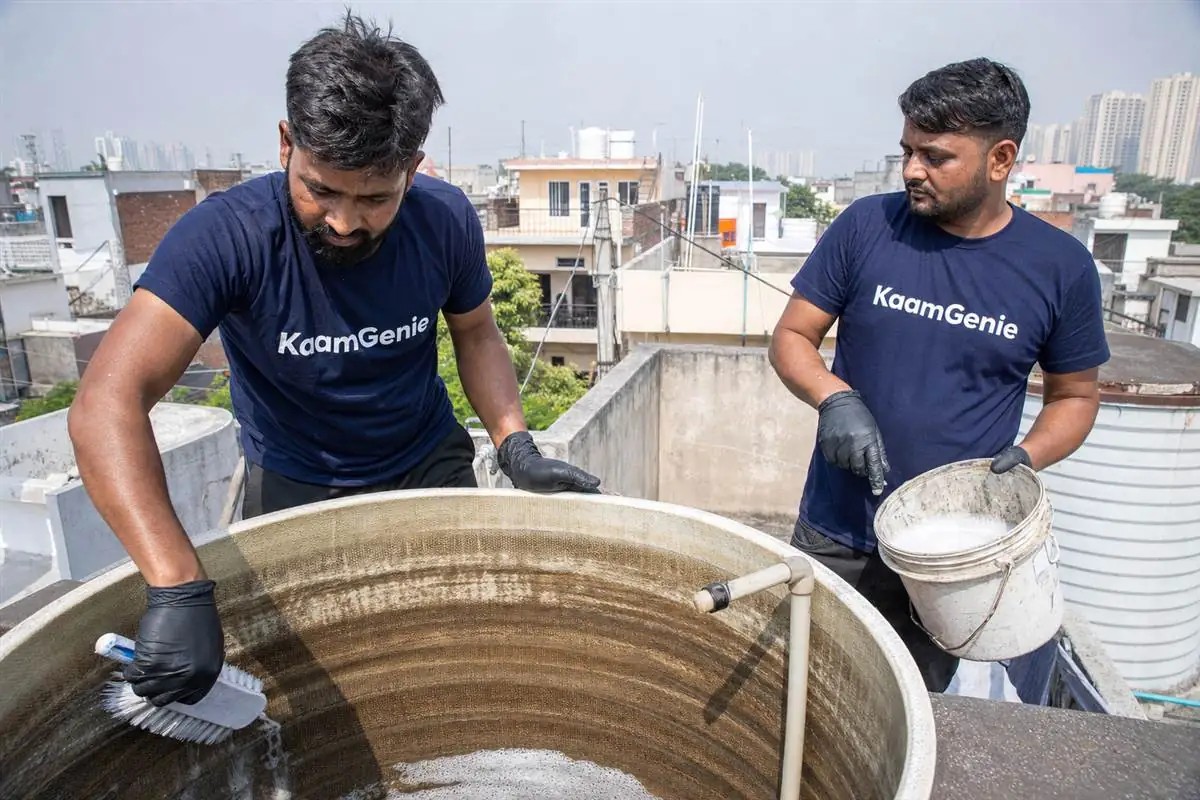 KaamGenie crew cleaning a water tank in Omega 1, Greater Noida