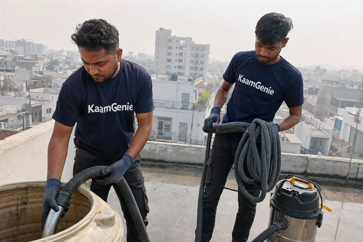 KaamGenie crew cleaning a water tank in Omega 2, Greater Noida