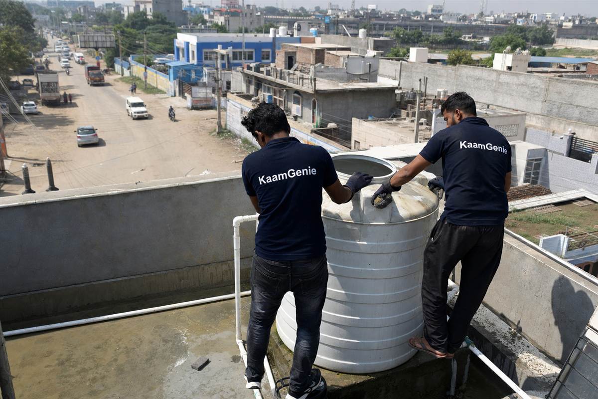 KaamGenie crew cleaning a water tank in Manesar, Gurgaon
