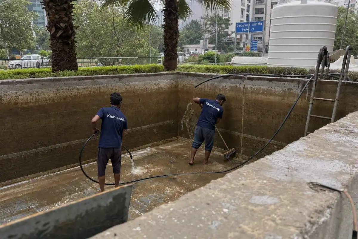 KaamGenie crew cleaning a water tank in Sector 71, Gurgaon