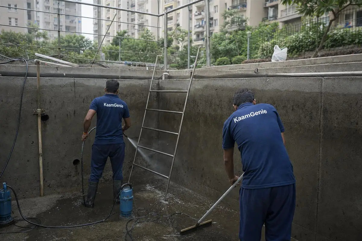 KaamGenie crew cleaning a water tank in Sector 78, Gurgaon