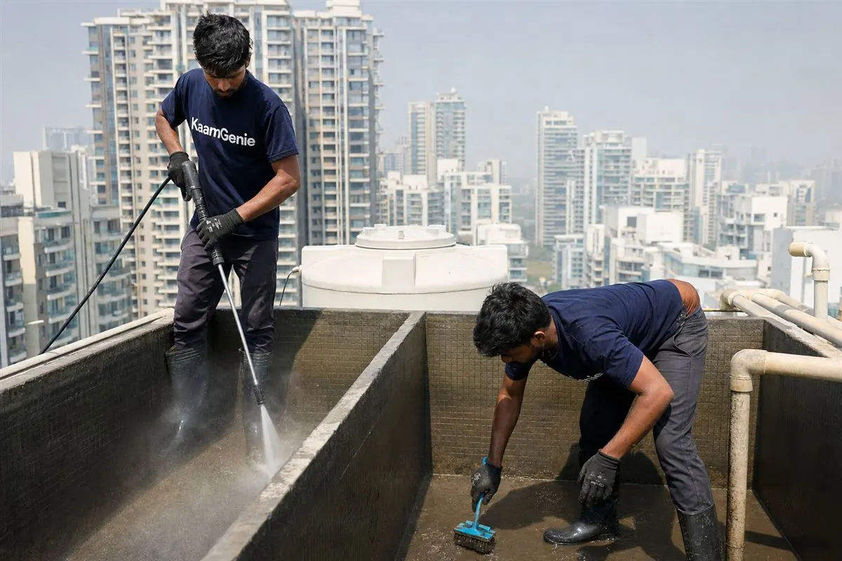 KaamGenie crew cleaning a water tank in Vatika City, Gurgaon