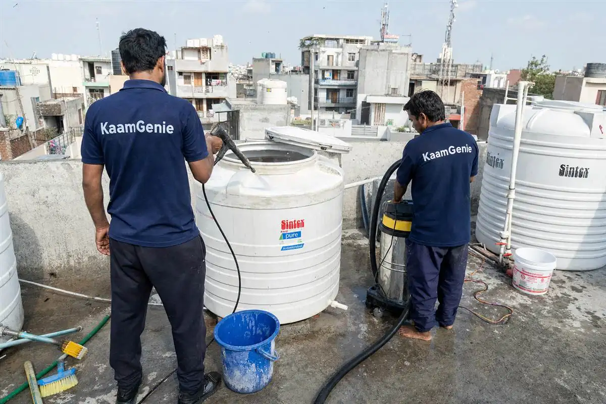 KaamGenie crew cleaning a water tank in Harkesh Nagar, Delhi