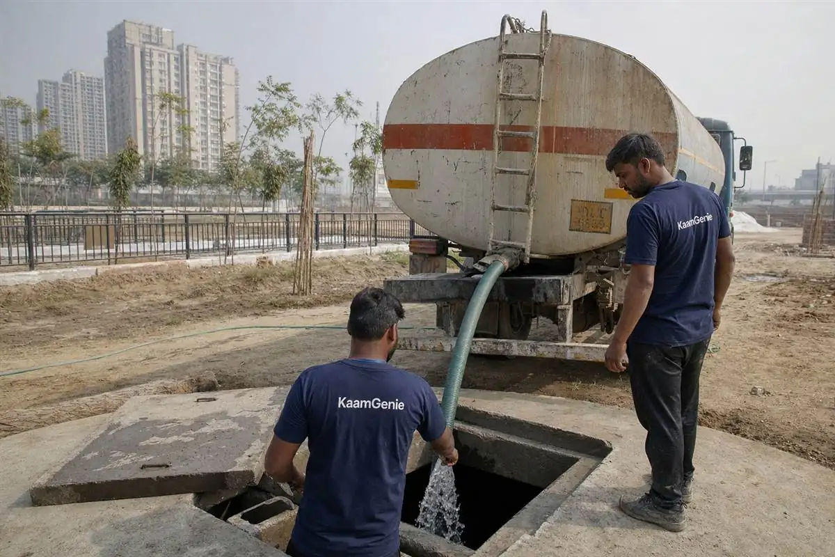 A water tanker discharging into the underground reservoir of a new township in the Jewar YEIDA corridor