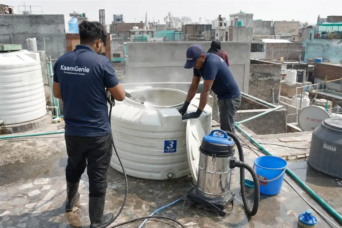KaamGenie crew cleaning a water tank in Khirki Village, Delhi