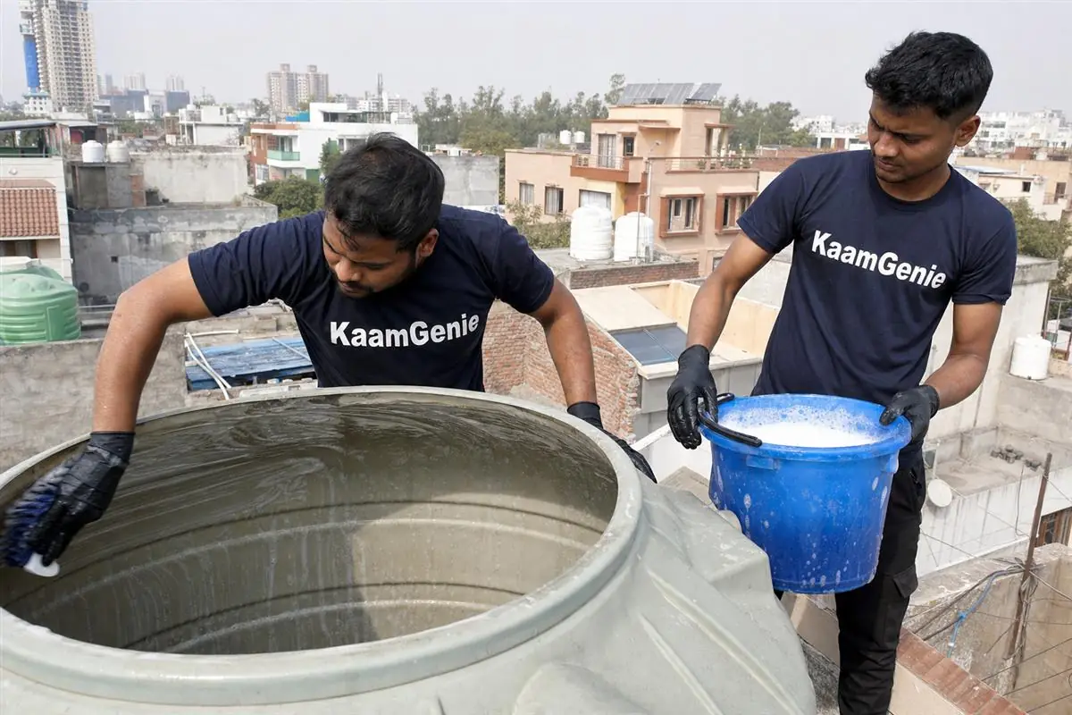 KaamGenie crew cleaning a water tank in Sector 111, Noida