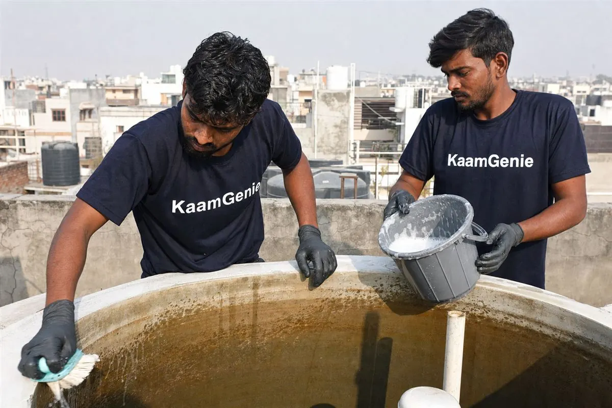 KaamGenie crew cleaning a water tank in Sector 123, Noida