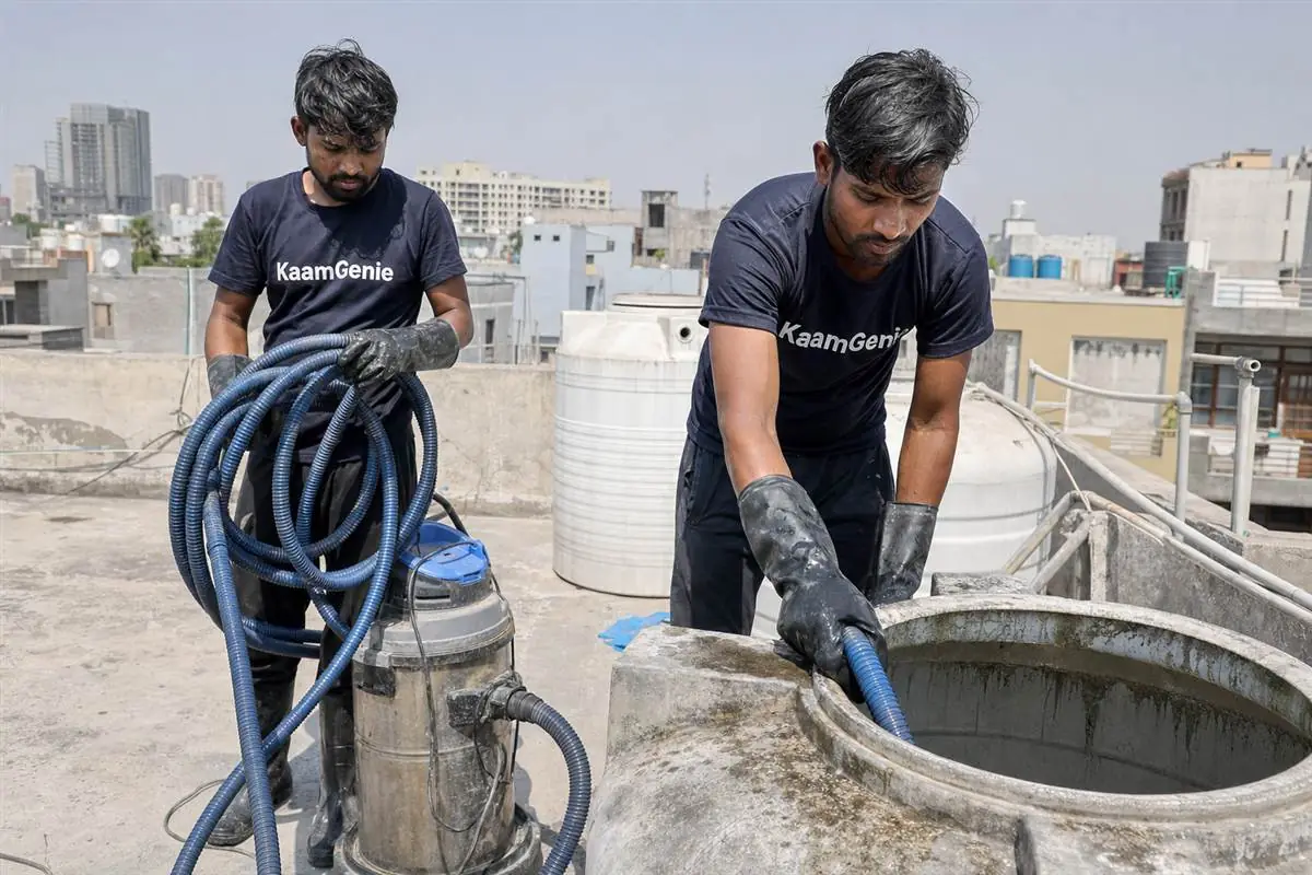 KaamGenie crew cleaning a water tank in Sector 125, Noida