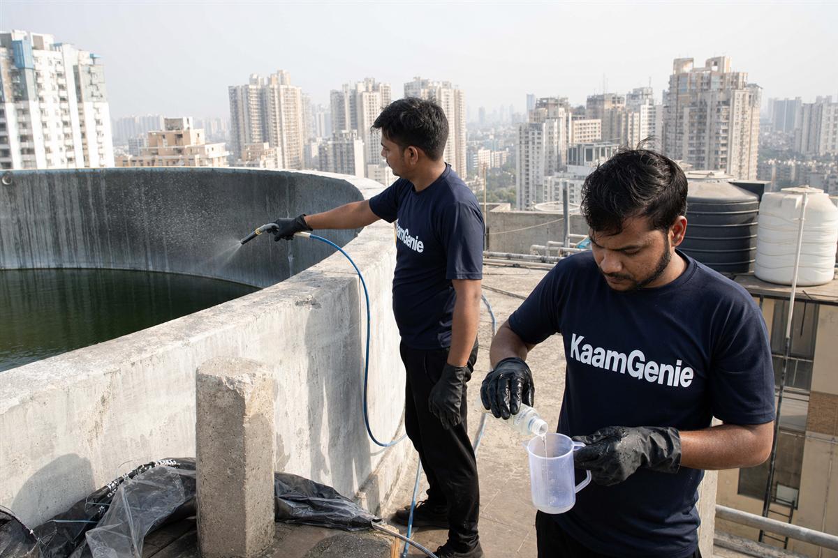 KaamGenie crew cleaning a water tank in Sector 143, Noida