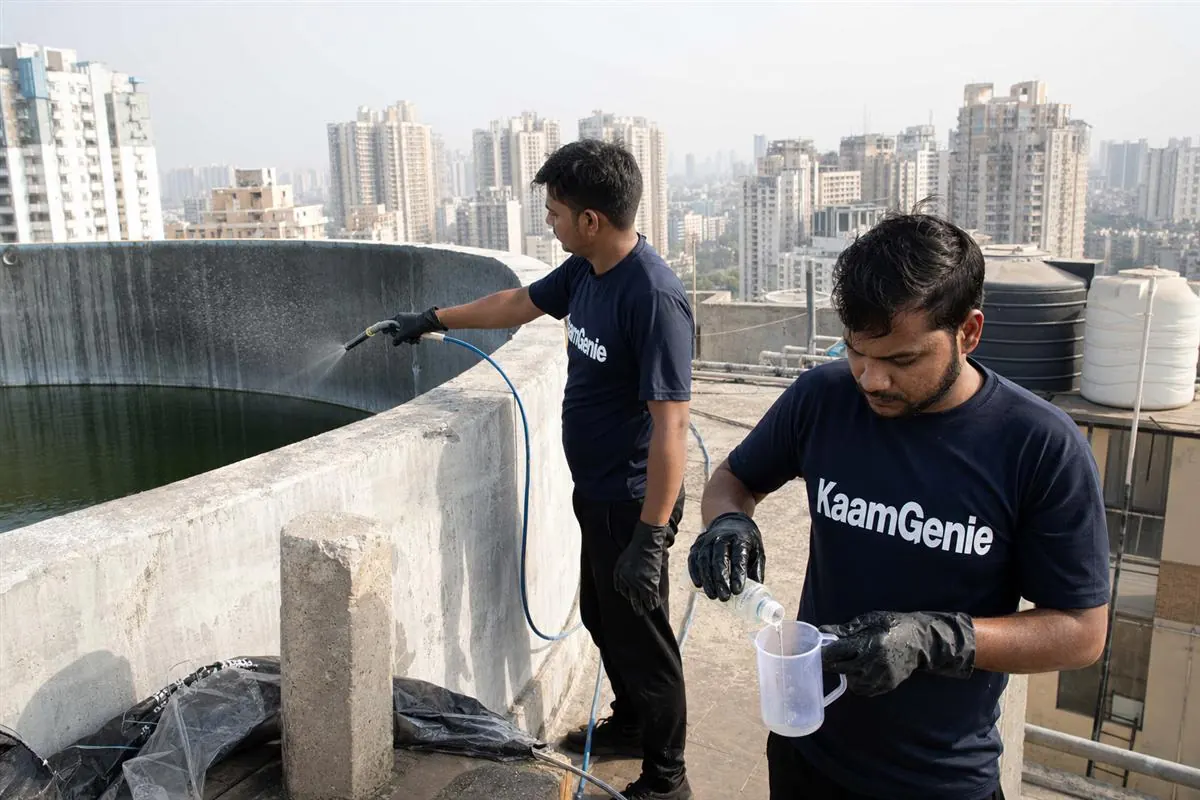 KaamGenie crew cleaning a water tank in Sector 143, Noida