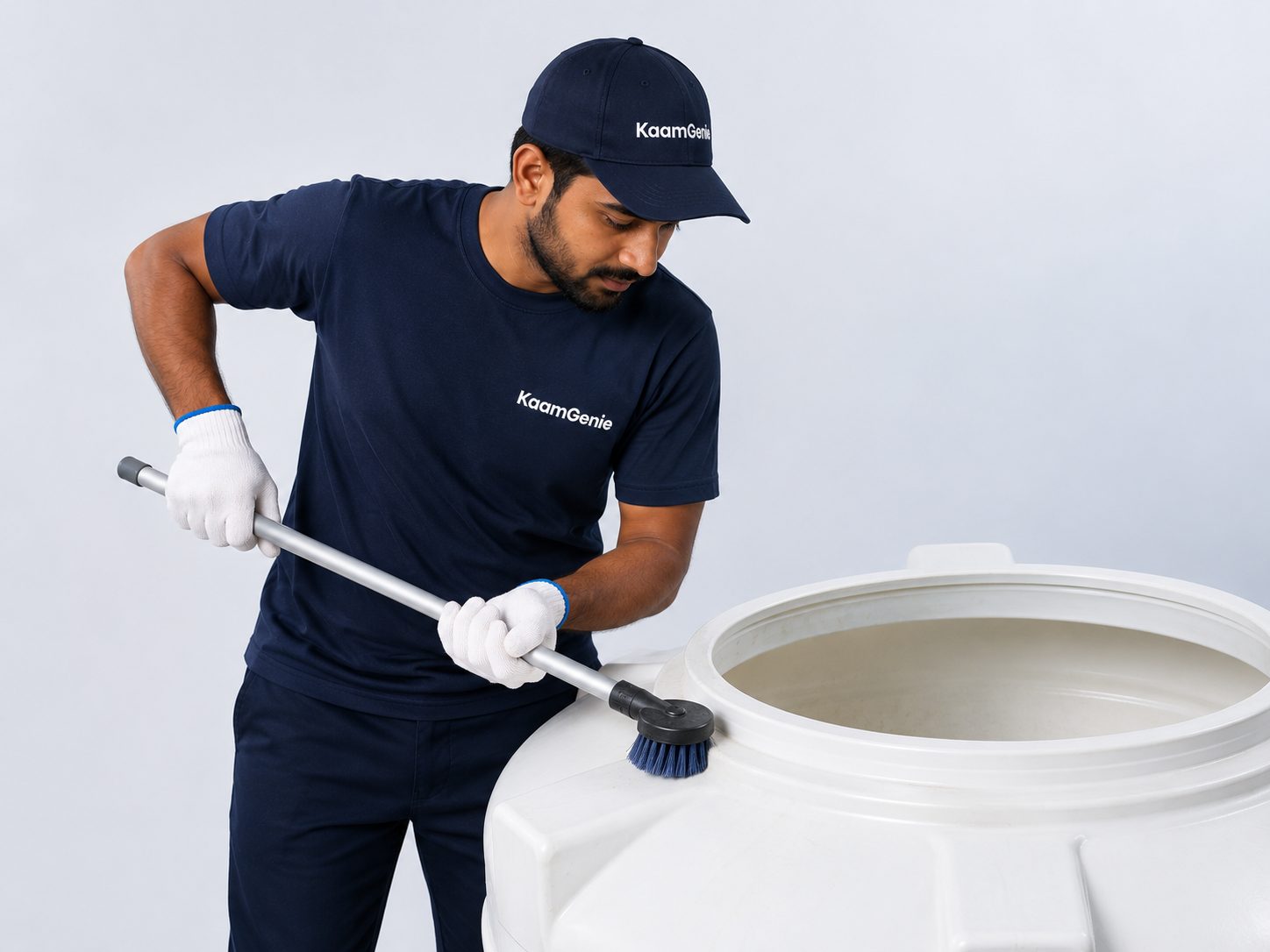 KaamGenie crew member cleaning an overhead water tank on a Delhi rooftop