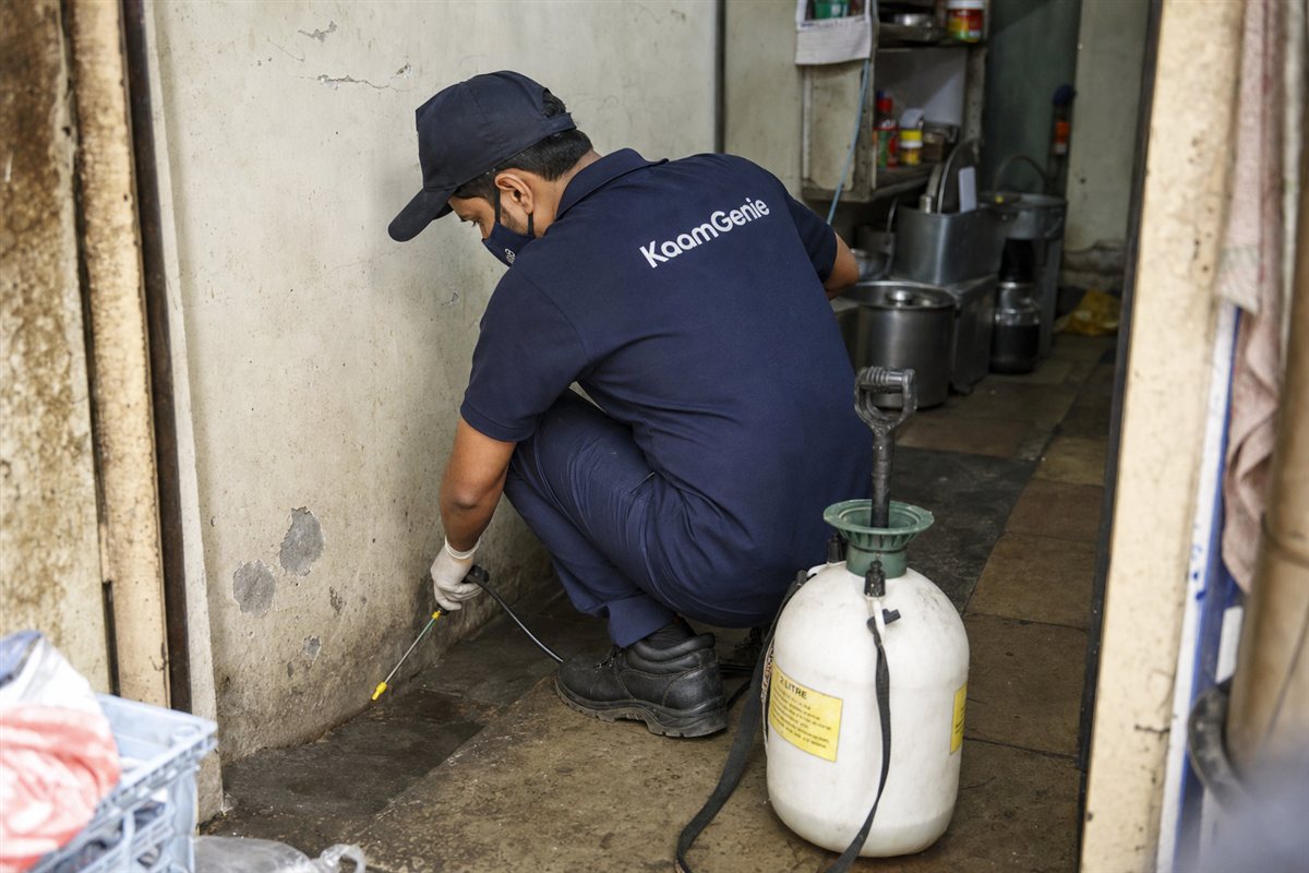 KaamGenie pest control technician treating a Anand Parbat property in North Delhi / Central Delhi