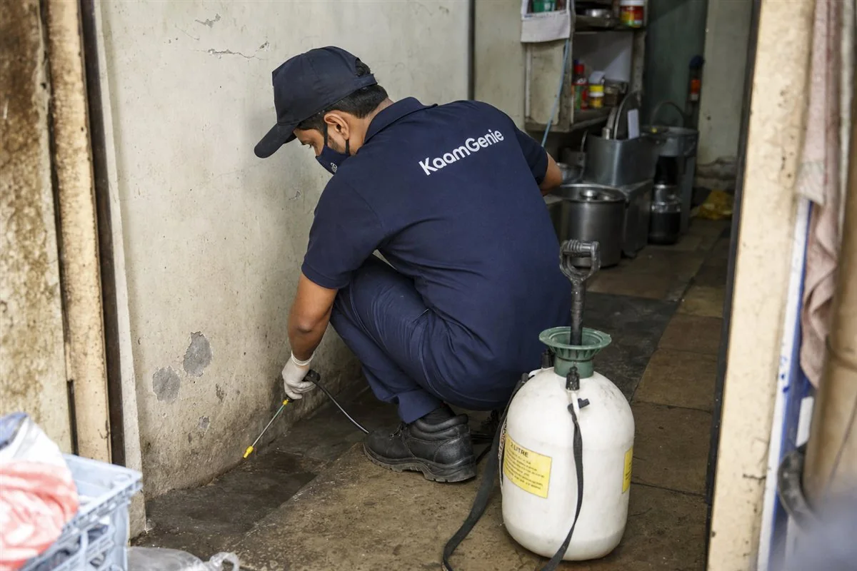 KaamGenie pest control technician treating a Anand Parbat property in North Delhi / Central Delhi
