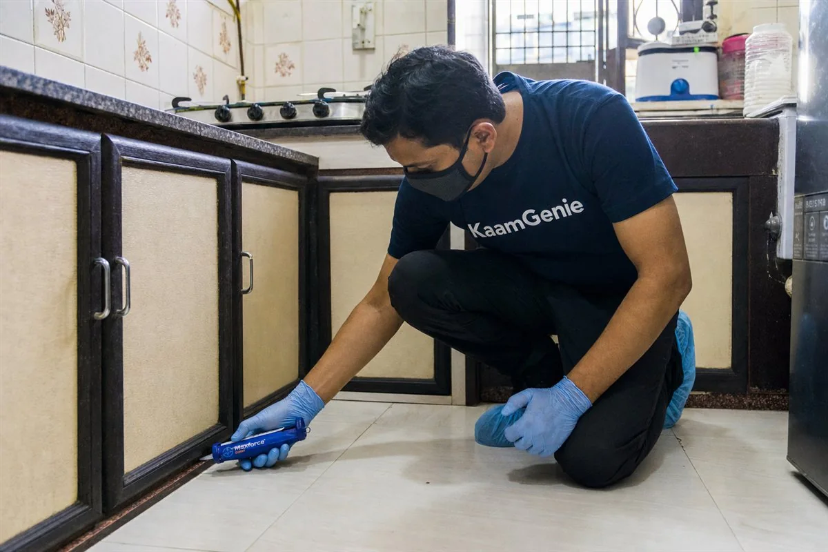 KaamGenie pest control technician treating a Anand Vihar property in East Delhi