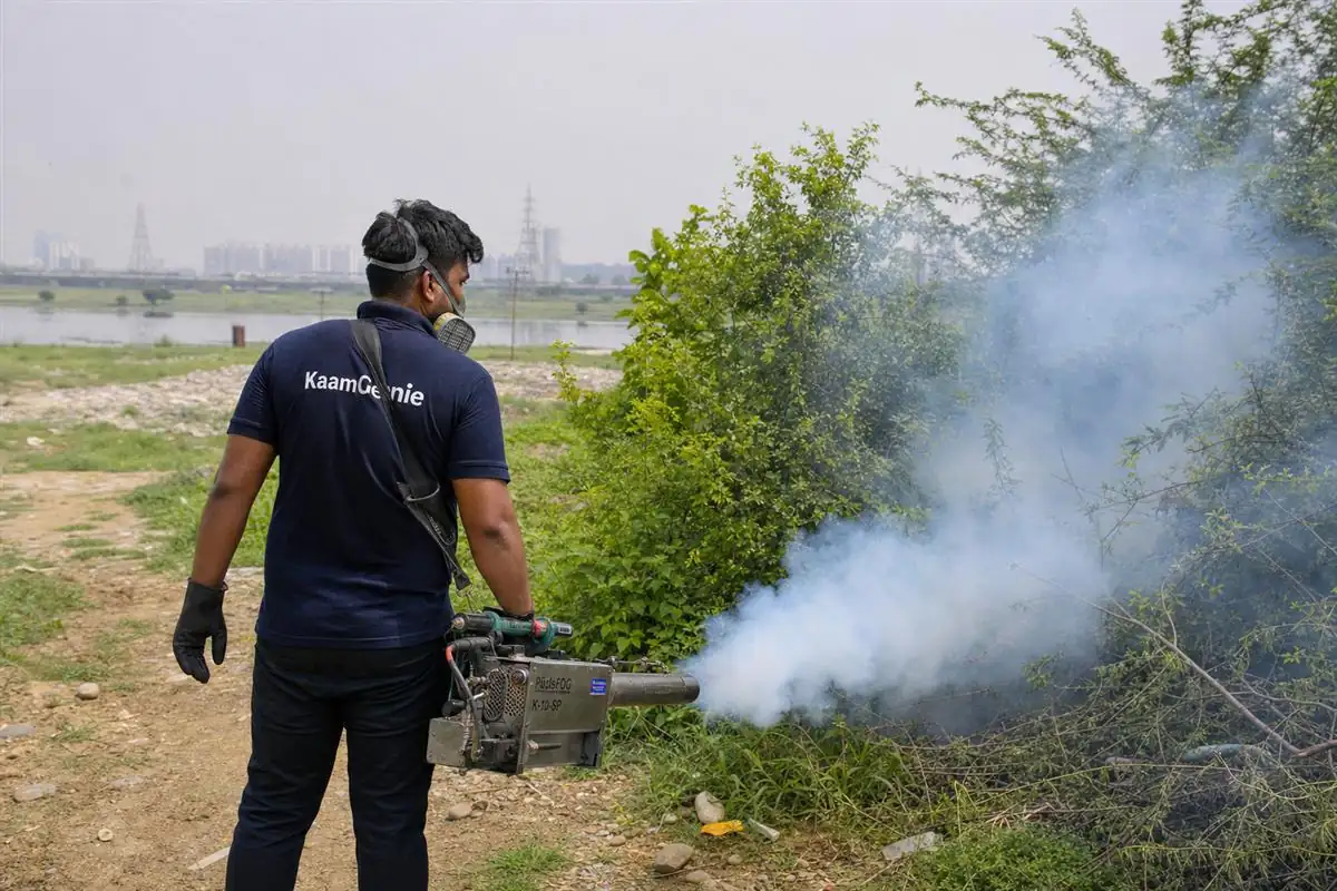 KaamGenie pest control technician fogging for mosquitoes near the Yamuna floodplain in Badarpur Khadar, South-East Delhi