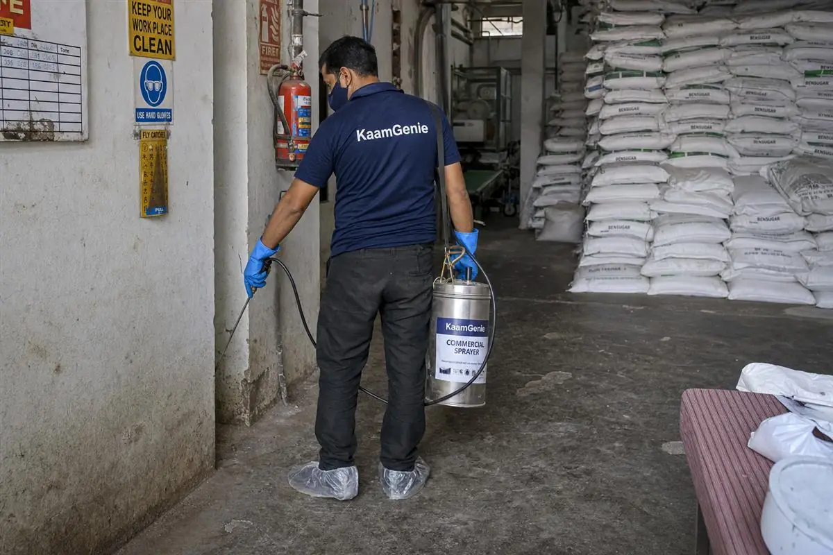 KaamGenie pest control technician treating a Bawana property in North-West Delhi