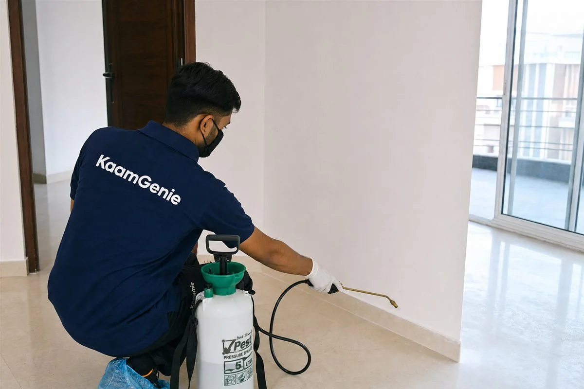 KaamGenie technician carrying out general pest control in an empty Delhi flat before the family moves in