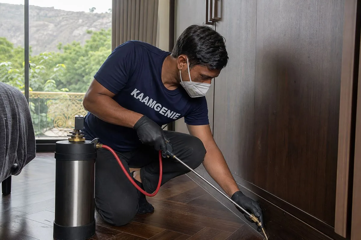 KaamGenie pest control technician treating a Charmwood Village property in Faridabad