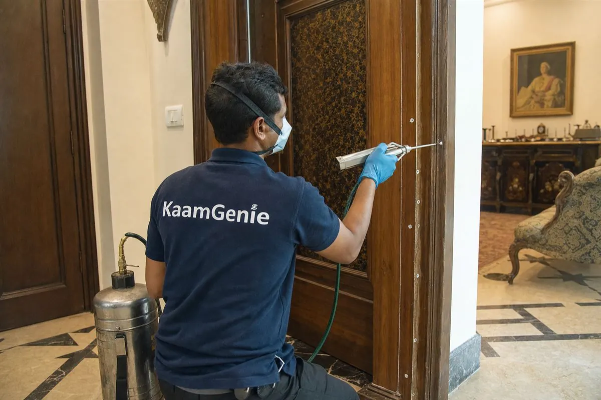 KaamGenie pest control technician treating a Friends Colony bungalow in South Delhi