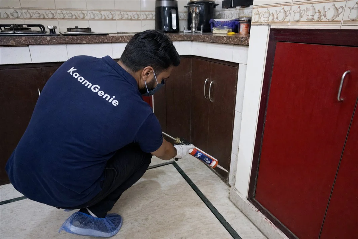 KaamGenie pest control technician treating a Gandhi Nagar Bazar property in East Delhi