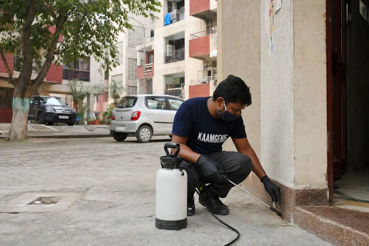 KaamGenie pest control technician treating a Gharoli property in East Delhi