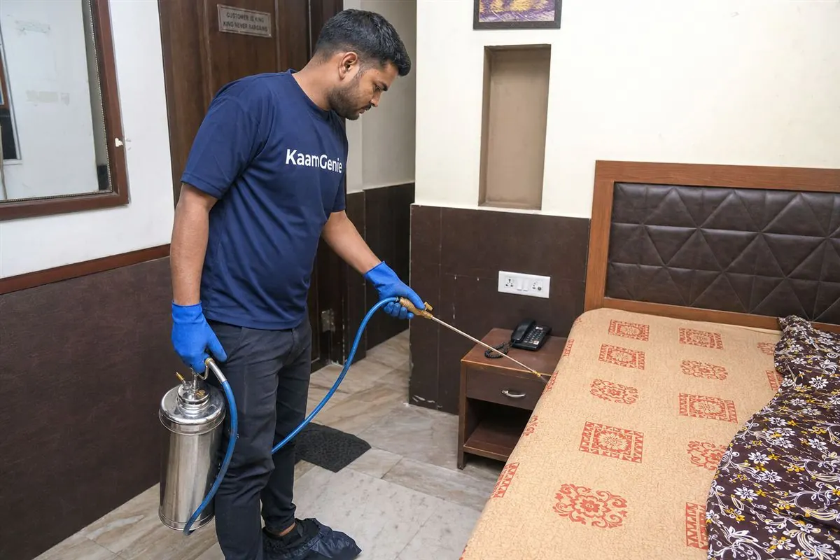 KaamGenie pest control technician treating a guesthouse near the dargah and railway station in Hazrat Nizamuddin, South-East Delhi