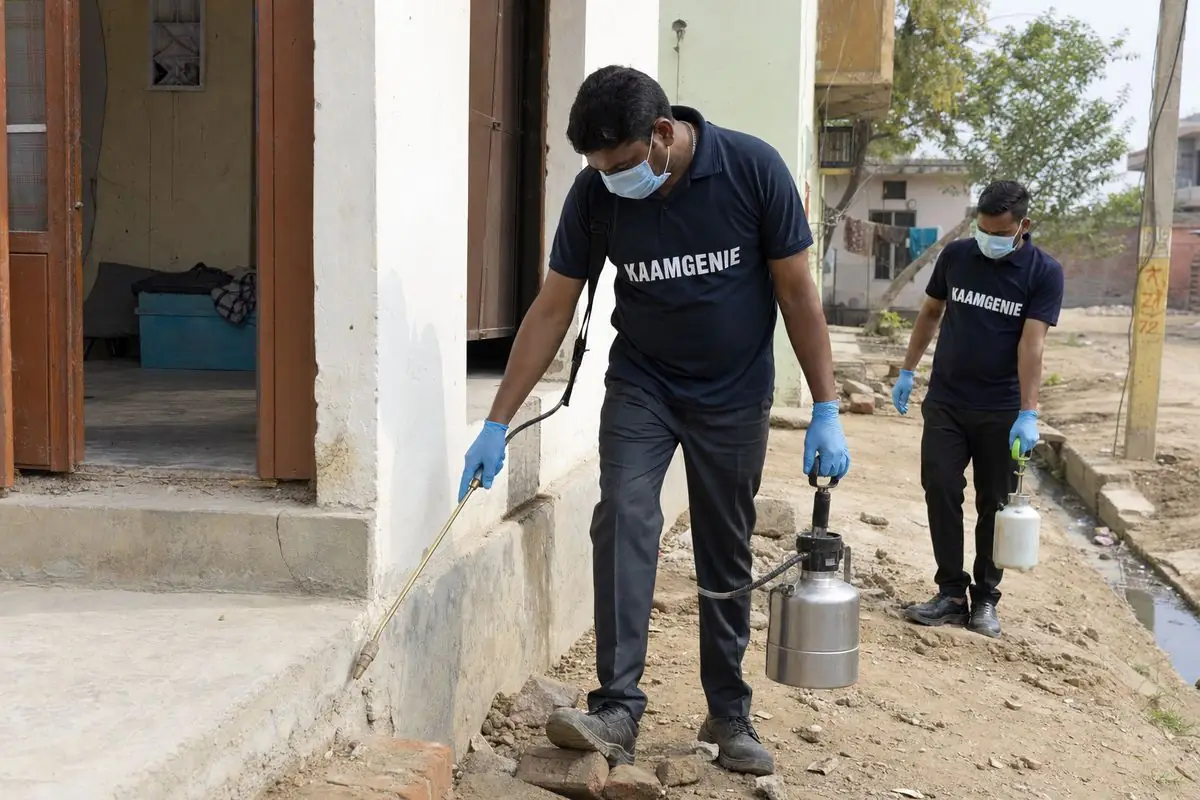 KaamGenie pest control technician treating a Holambi Kalan property in North-West Delhi