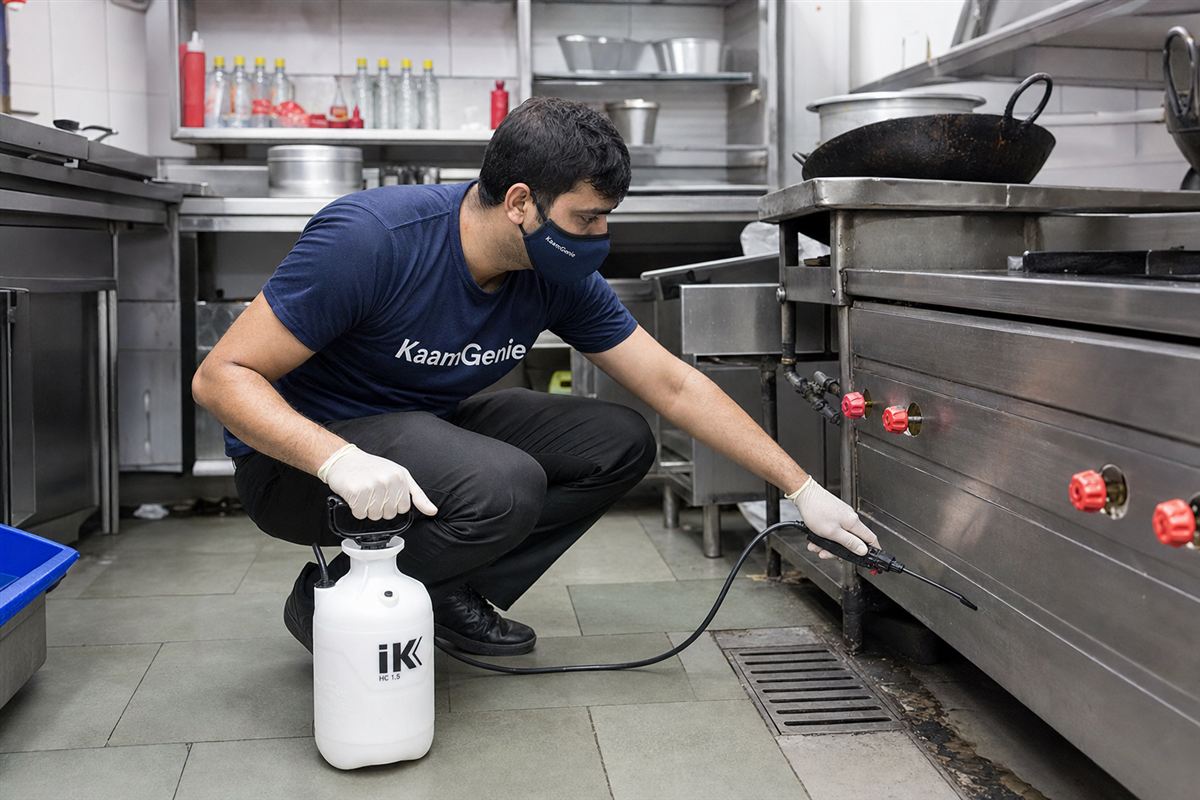 KaamGenie pest control technician treating a Jafrabad property in East Delhi