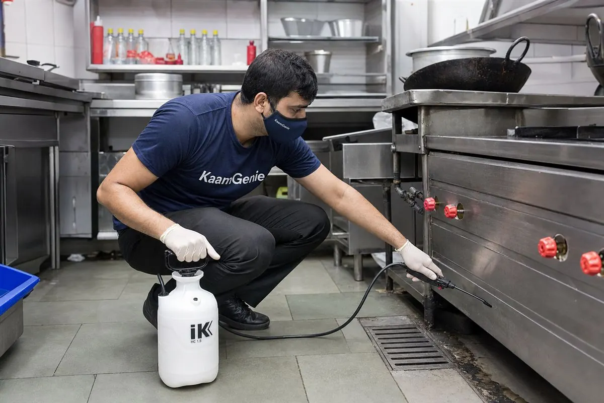 KaamGenie pest control technician treating a Jafrabad property in East Delhi
